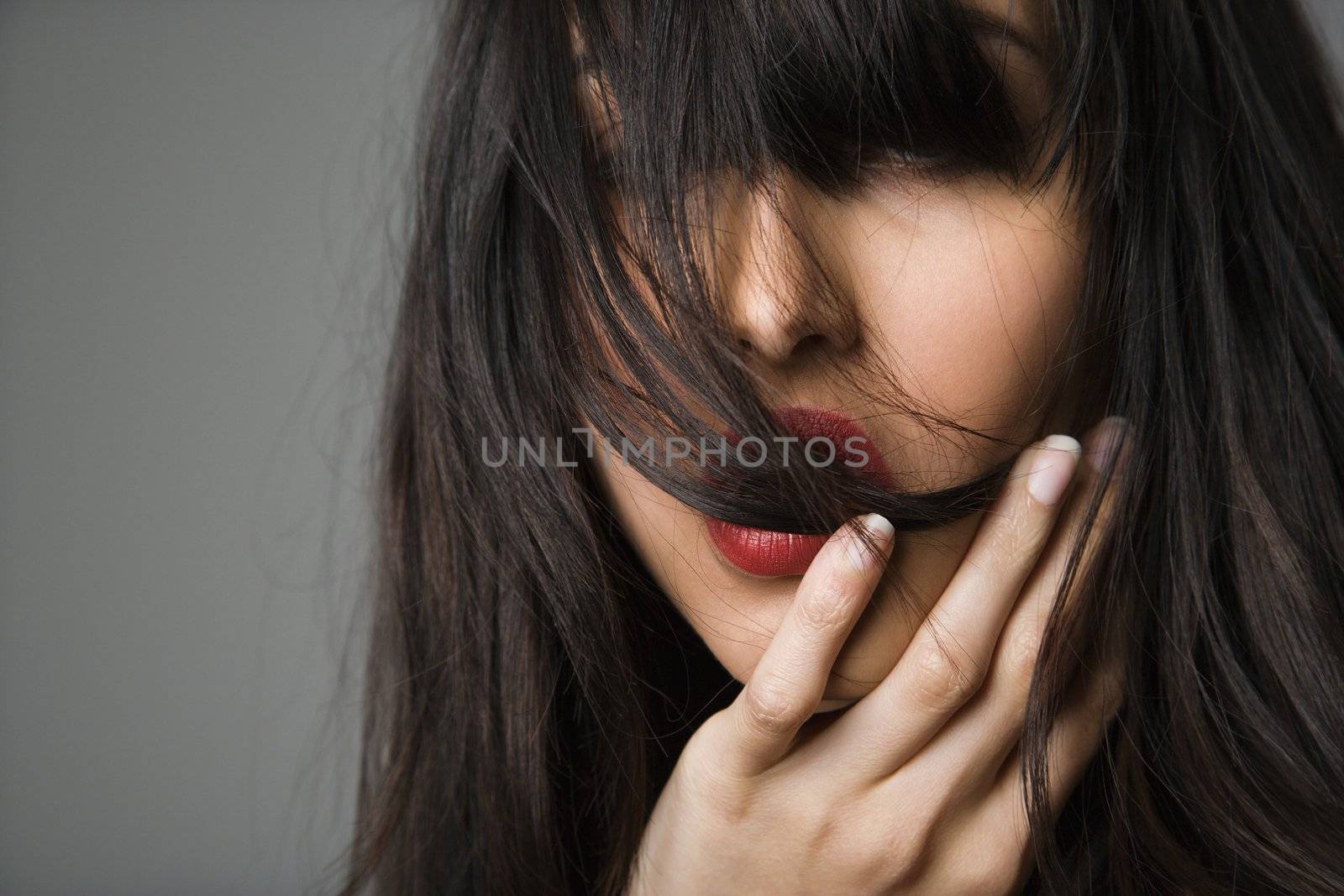 Headshot of pretty young woman with long black hair.