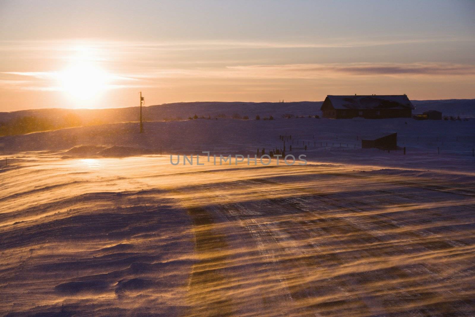 Ice covered road and snowy rural landscape.