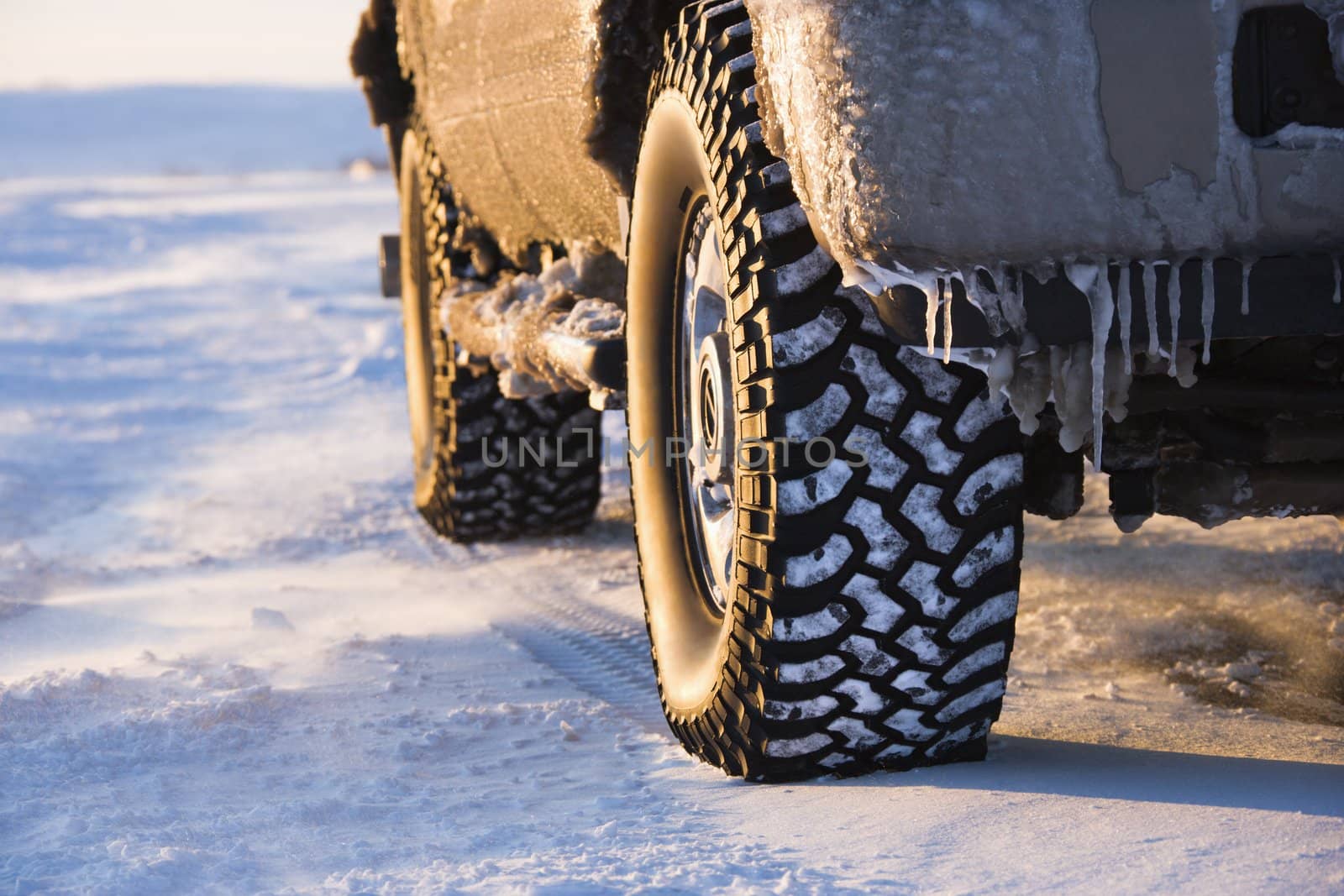 Close up of truck on ice covered road.