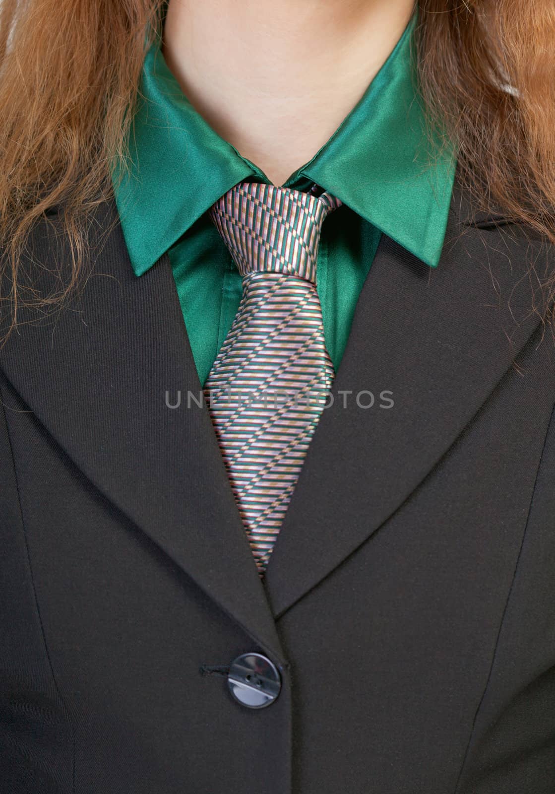 Fragment of a female business suit - a collar and a tie