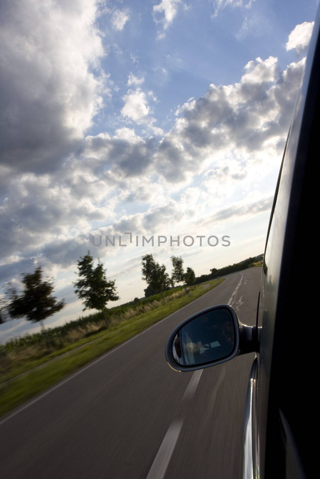 detail of a car driving on a country road by bernjuer