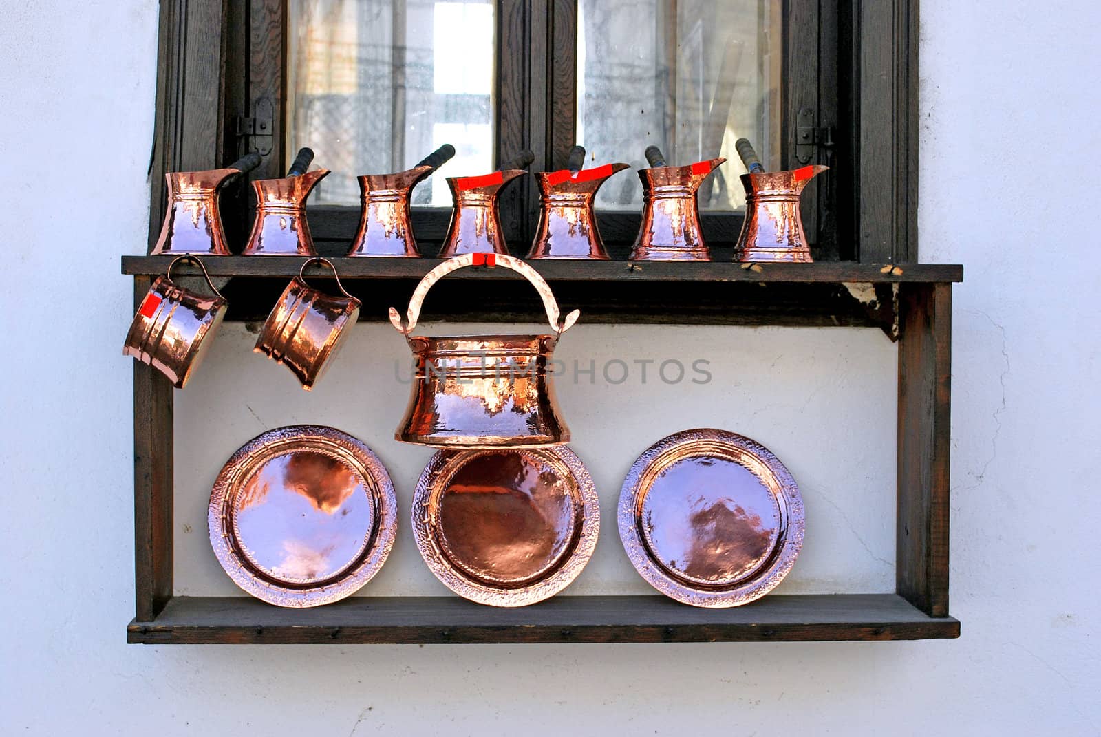 copper utensils on a wooden window