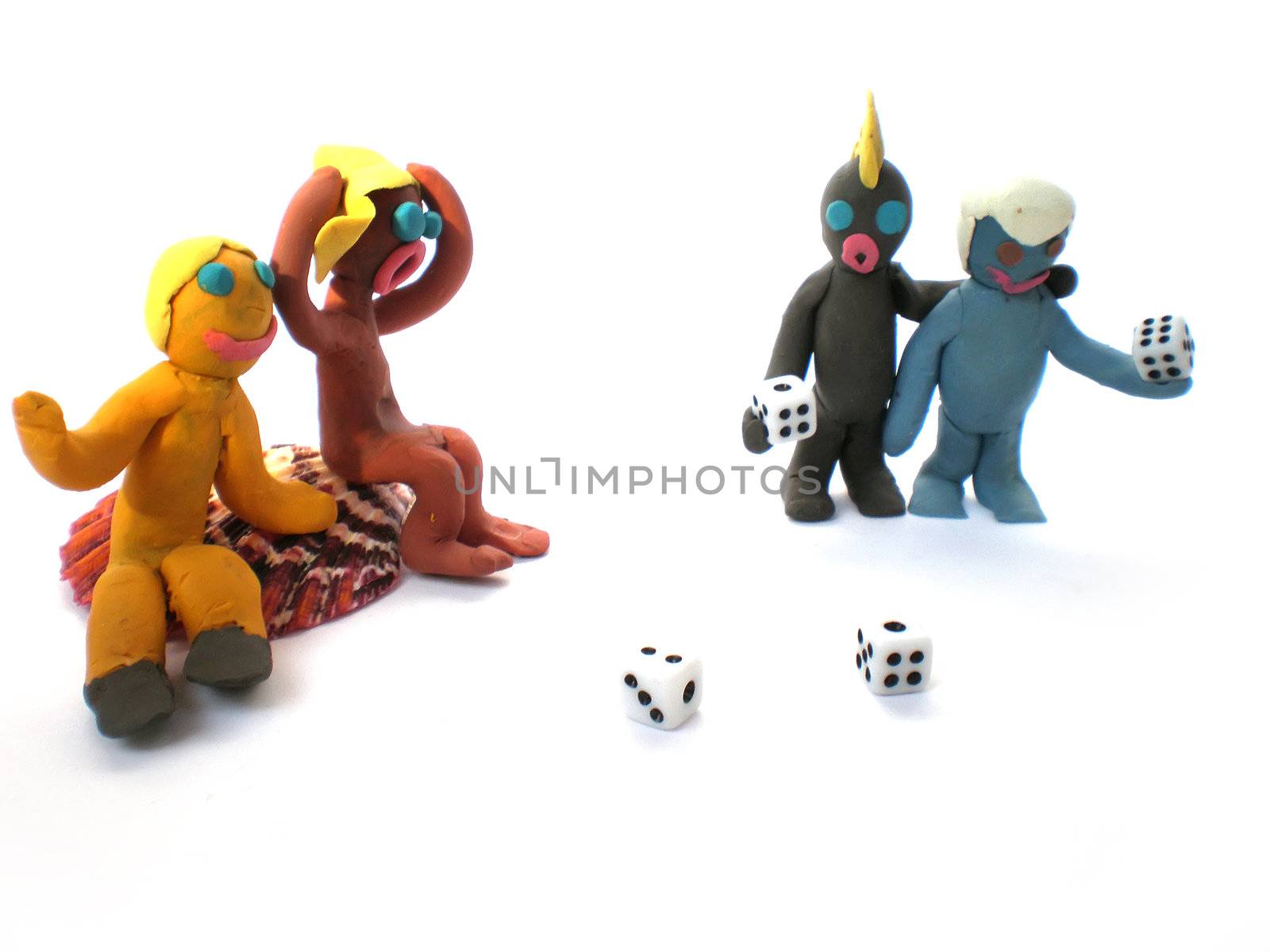 plasticine people figures playing with dice on white background
