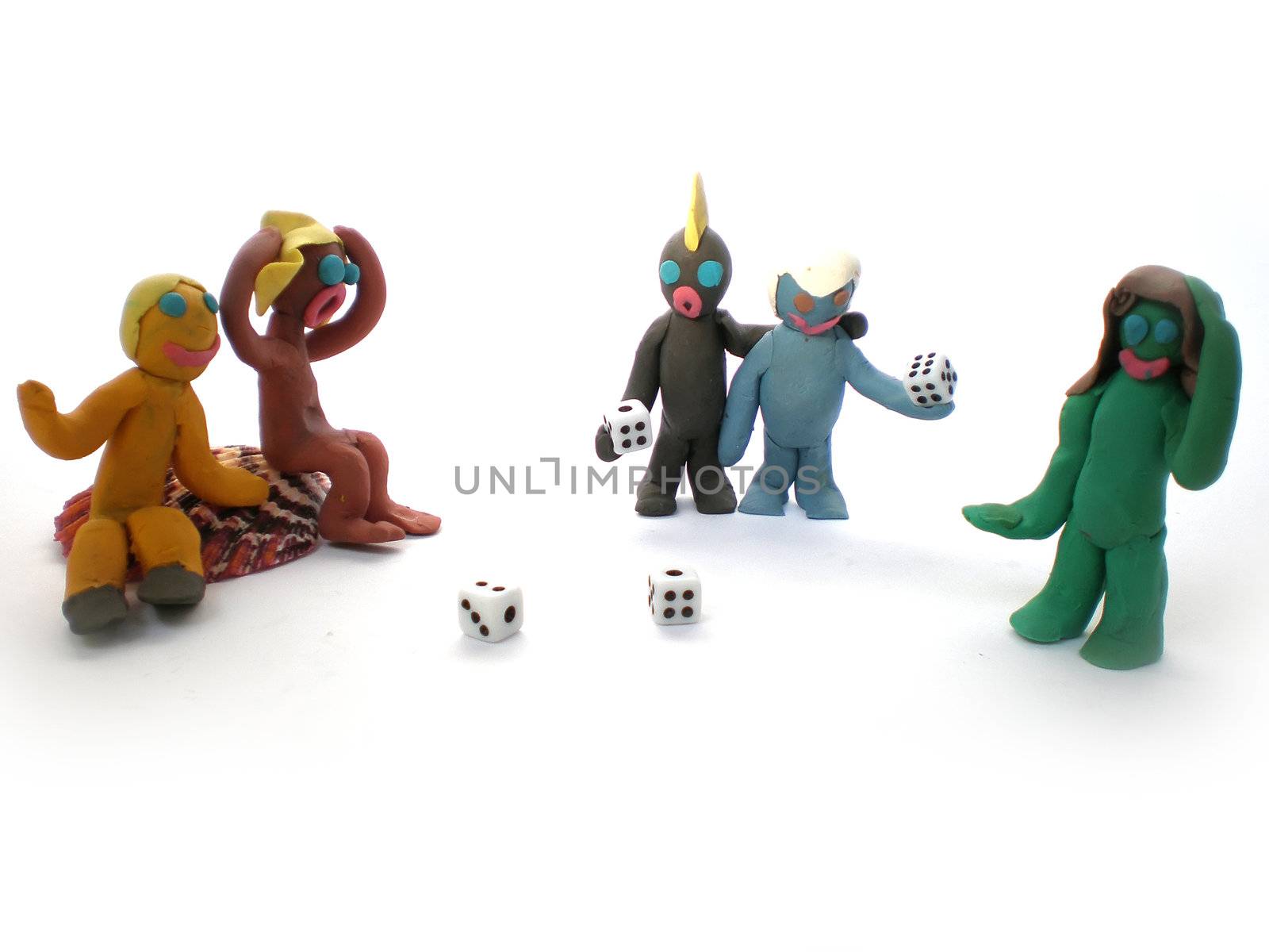 plasticine people figures playing with dice on white background