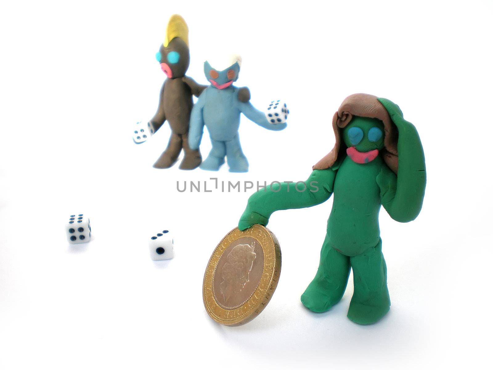 plasticine people figures playing with dice on white background