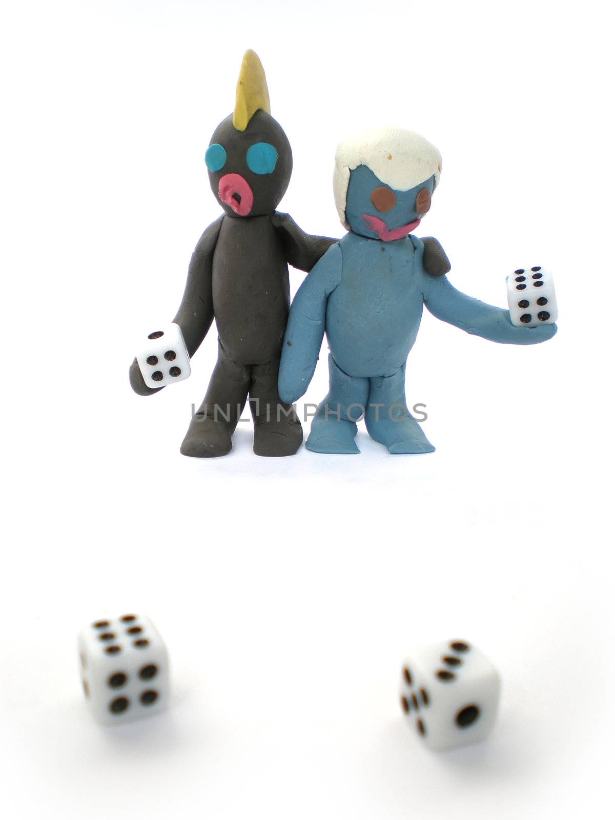 plasticine people figures playing with dice on white background