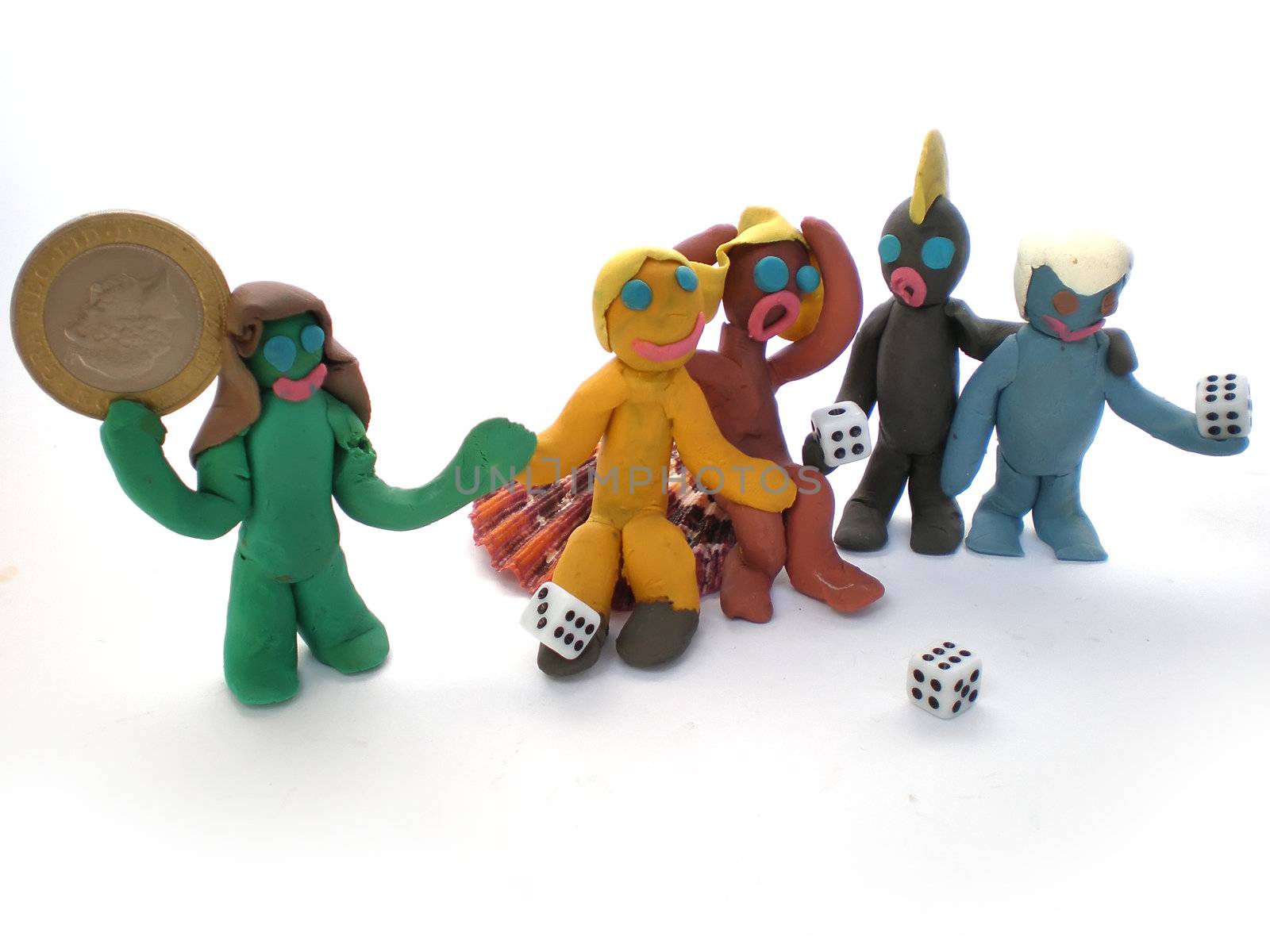 plasticine people figures playing with dice on white background