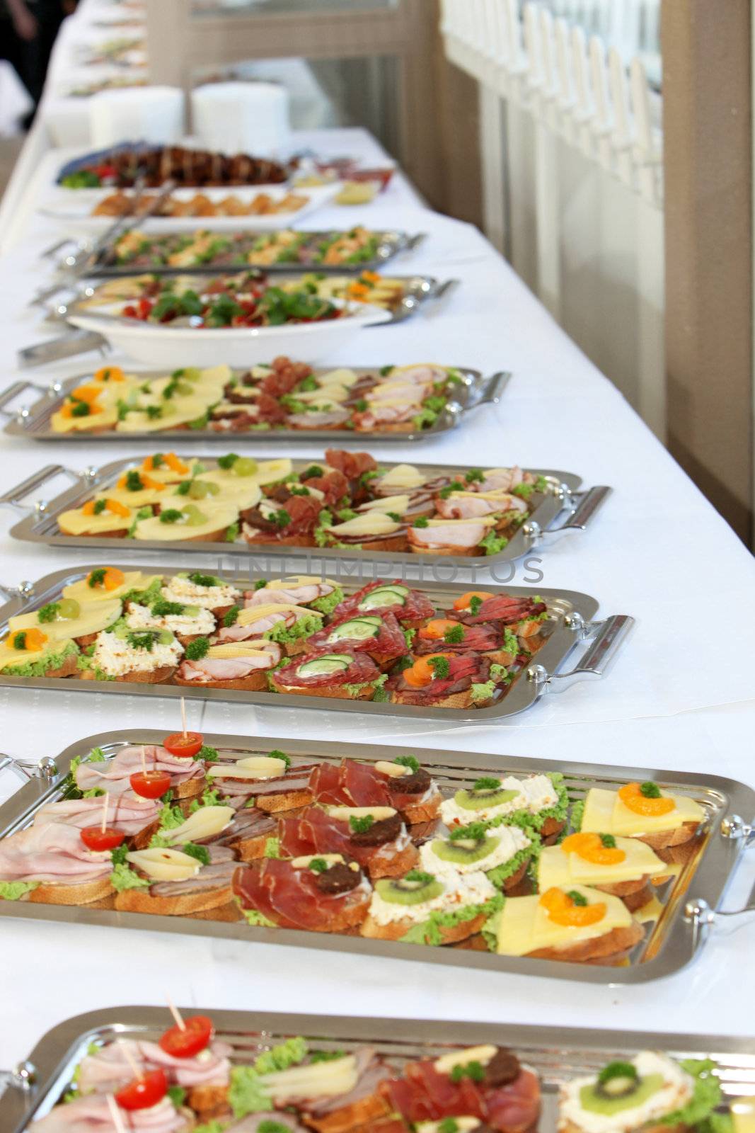 Buffet on a long table with appetizers or finger food