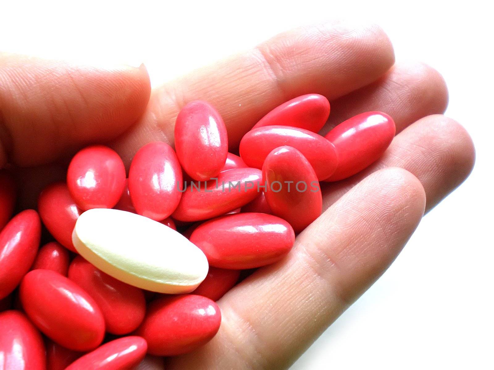 pile of pills in hand isolated on white background
