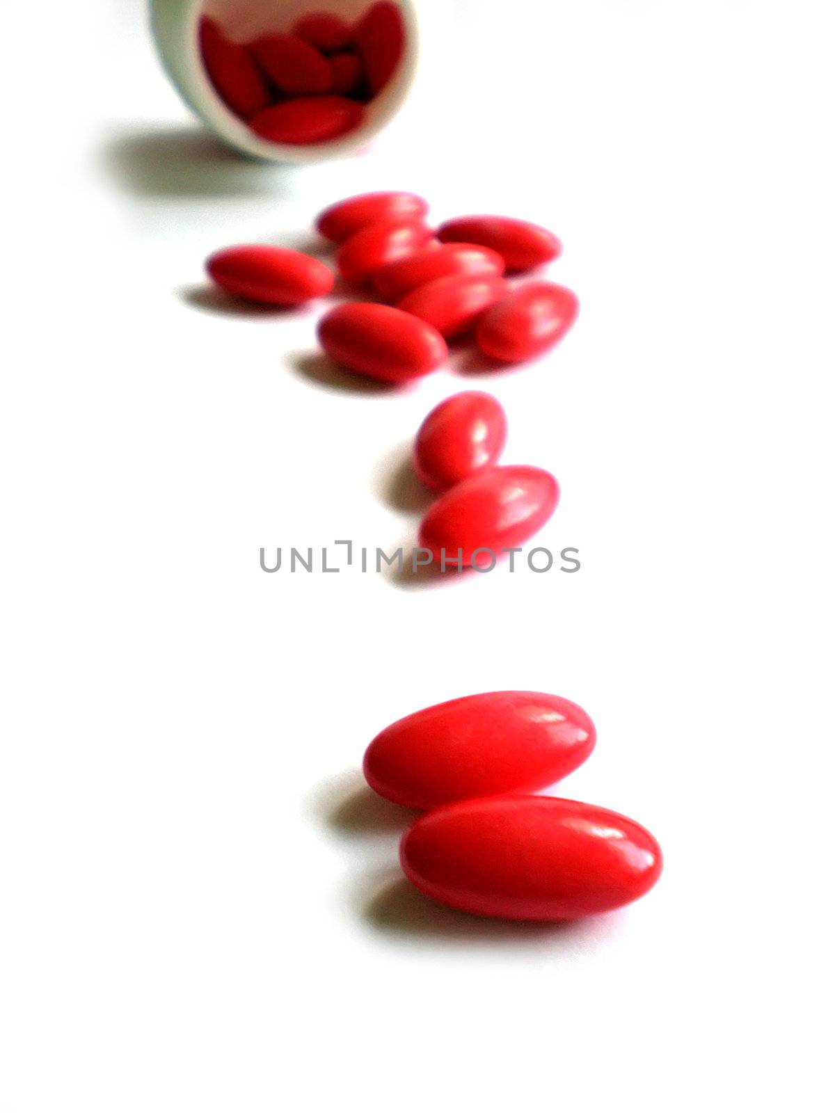 pile of pills and bottle isolated on white background