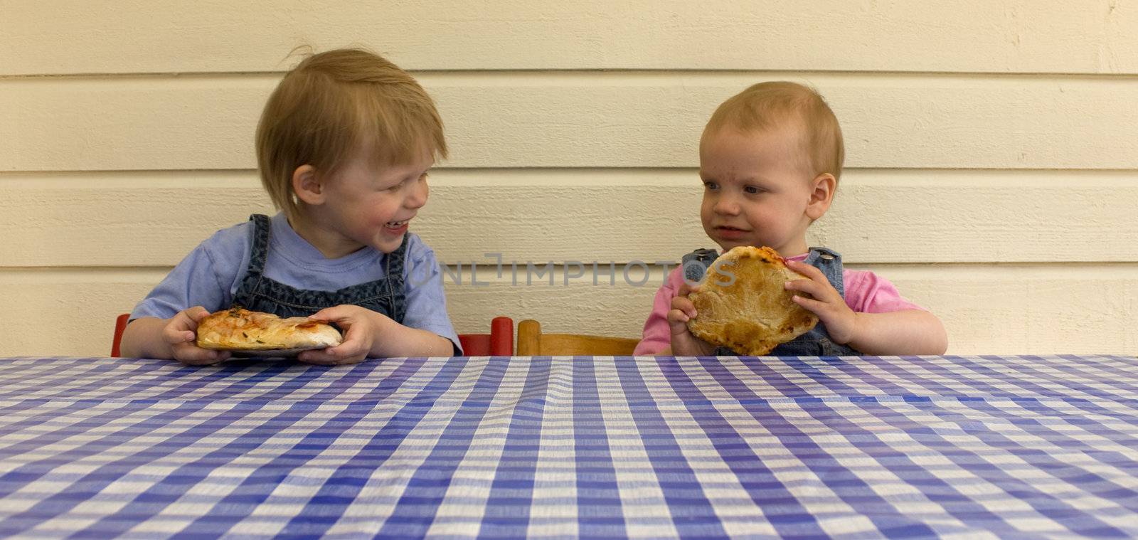 Children eating homemade rustique pizzas together