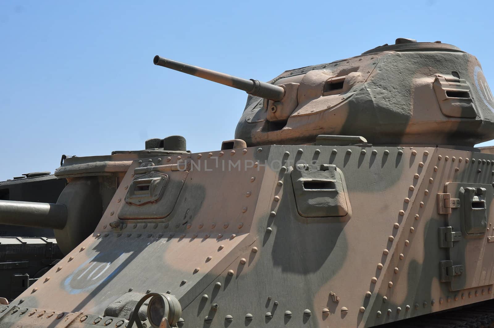 Old tank against the blue sky . Israel, Latrun.