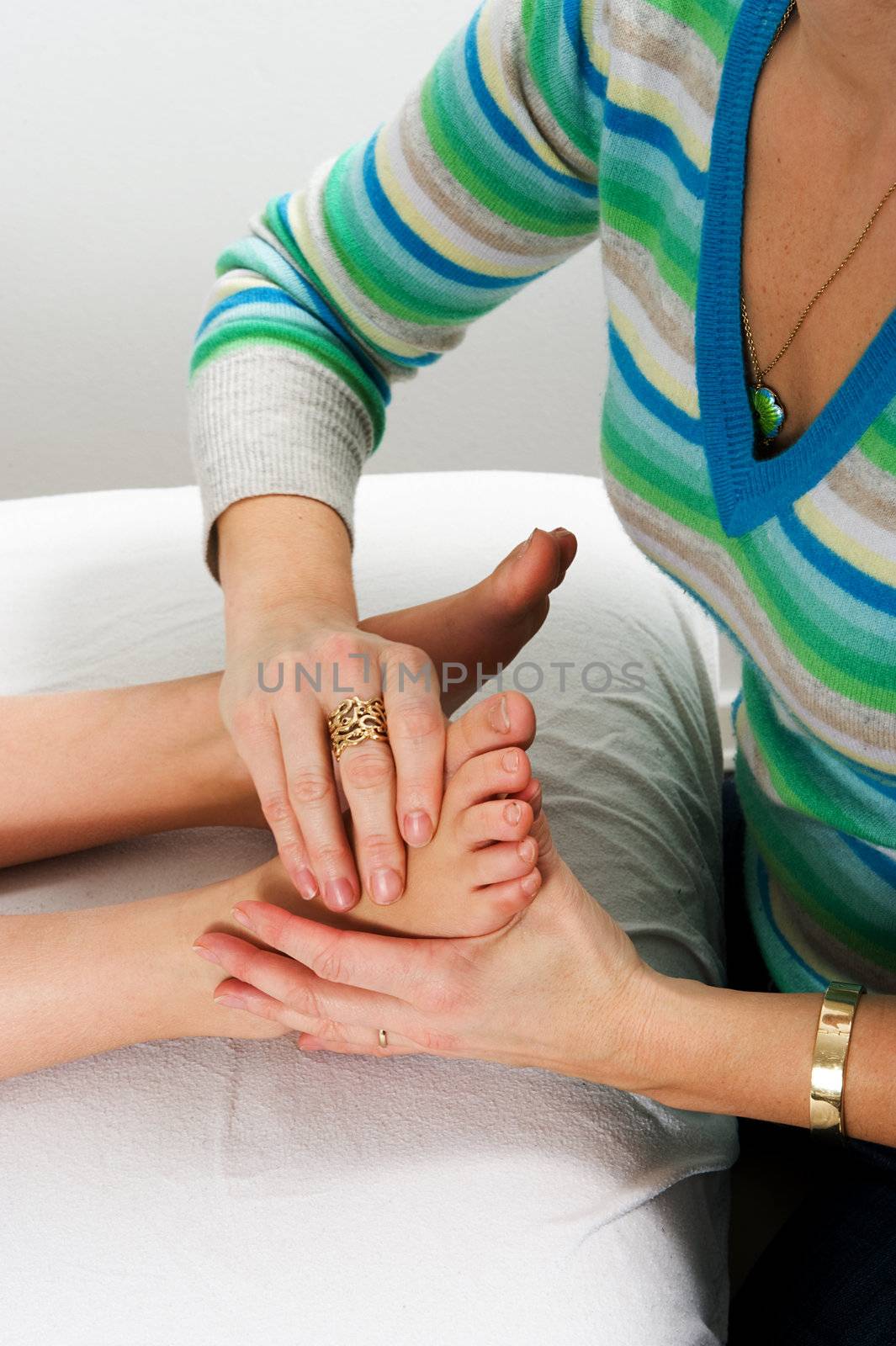 Closeup of teenagers foot during massage treatment at health cen by fljac