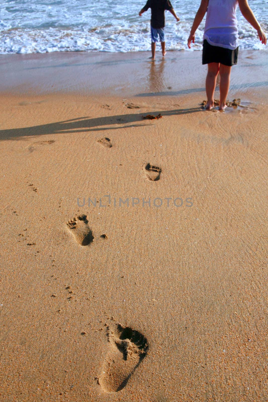 Footprints of children leading into the Ocean