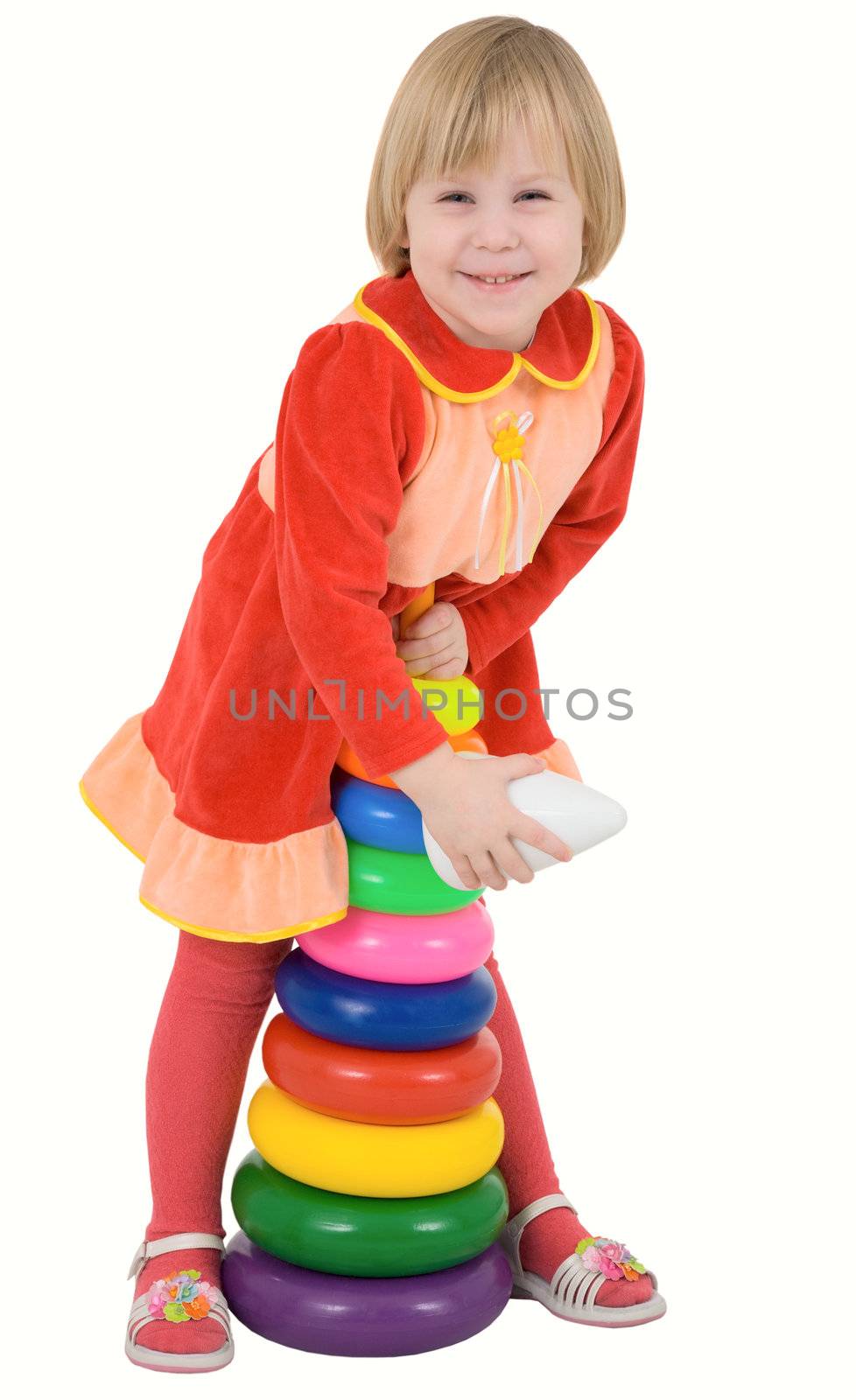 Child in the red dress with toy on a white 
