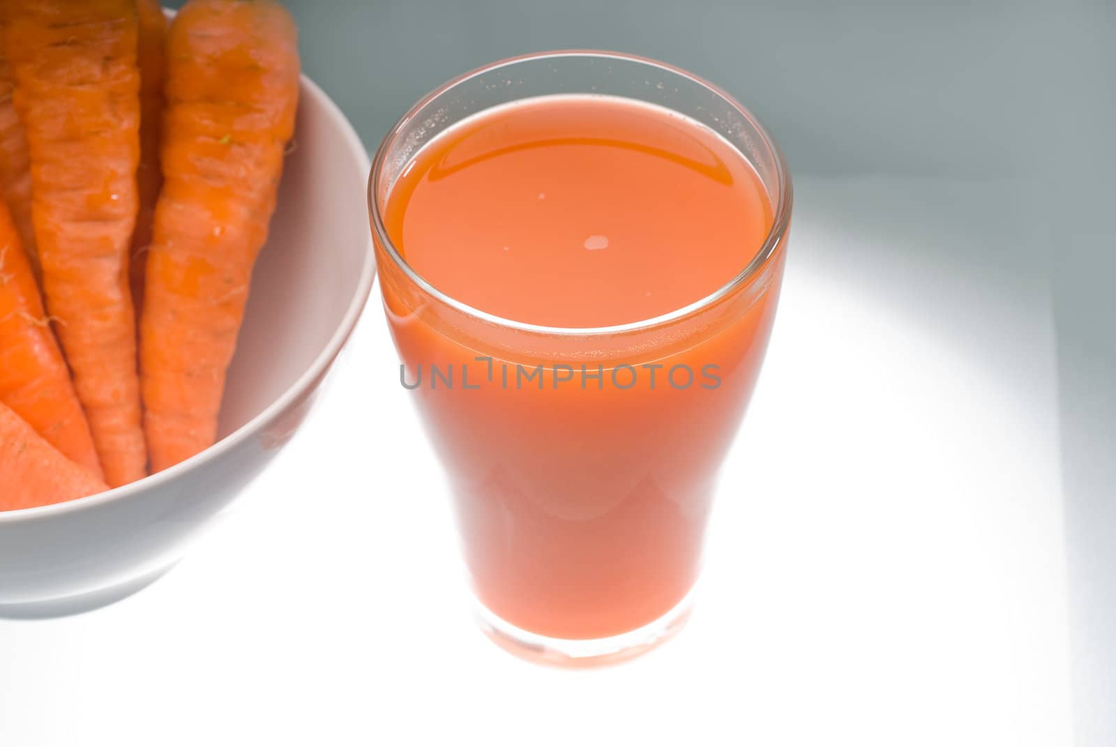 fresh and healty carrot juice unfiltered over a light table