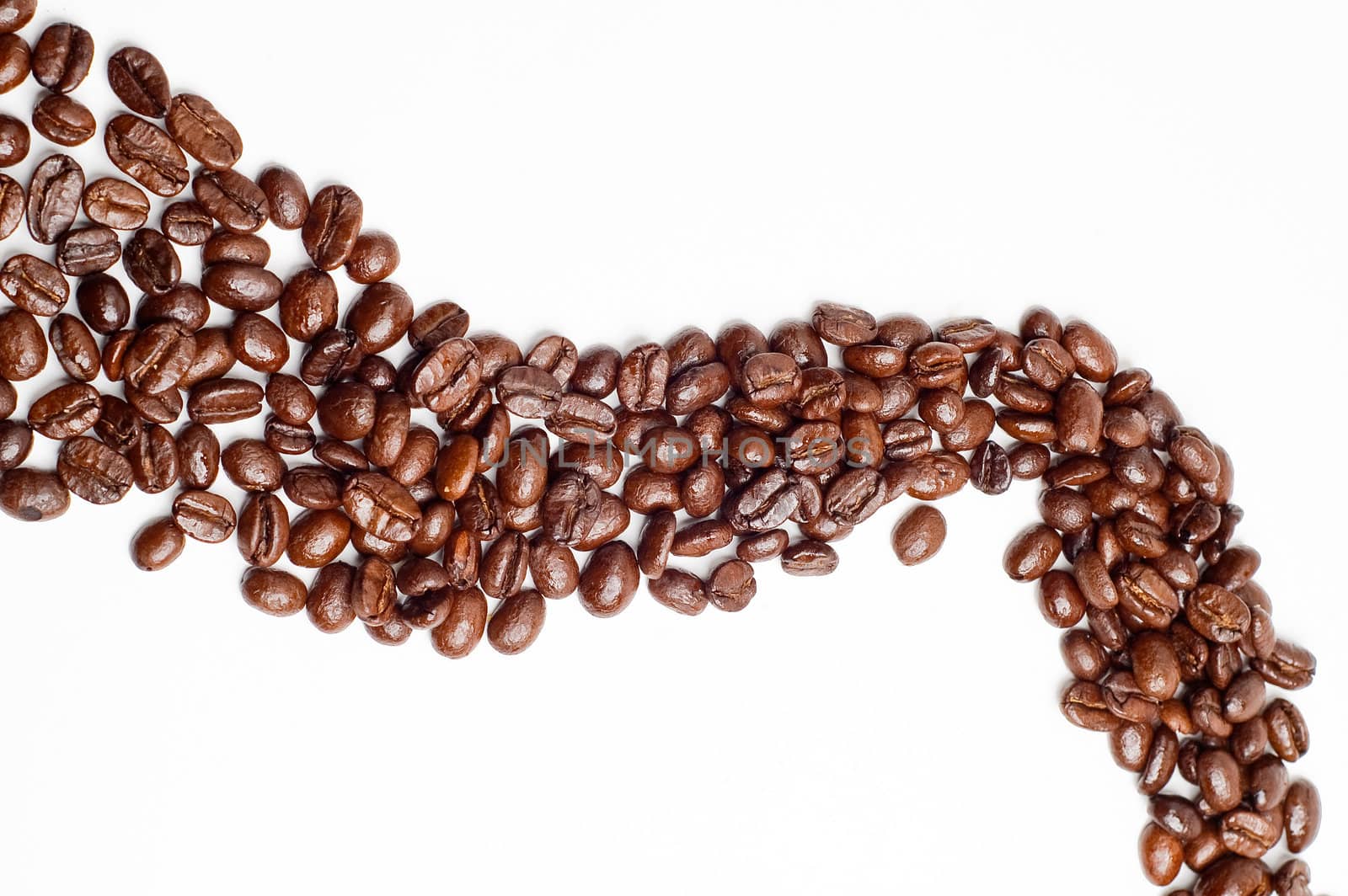 bounch of roasted coffee beans mimic a road shape