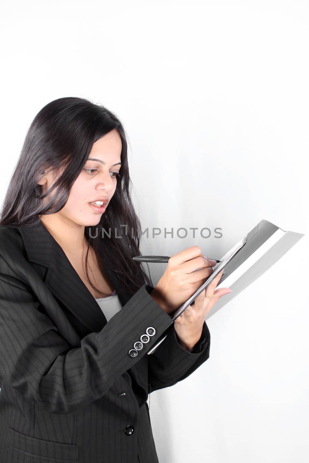 An Indian businesswoman signing a business contract.