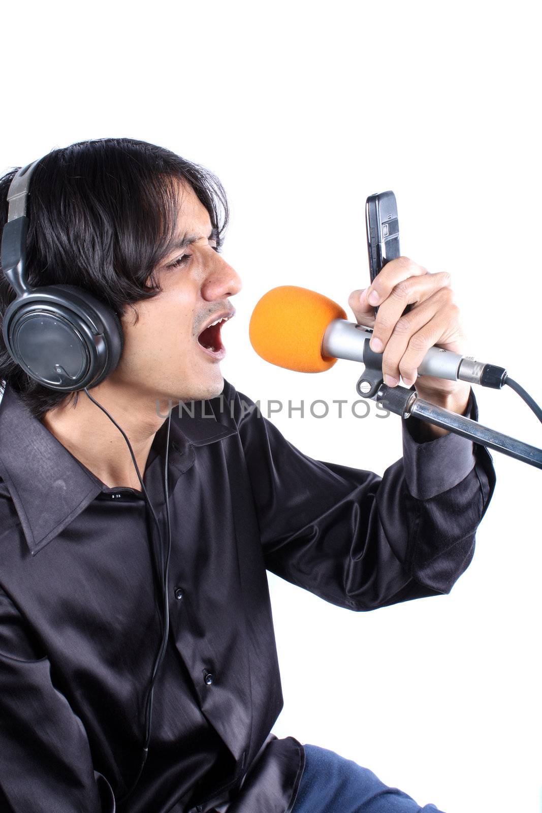 A metaphorical image of a singer recording a ringtone / dialler-tone for a record company in music studio, on white studio background.