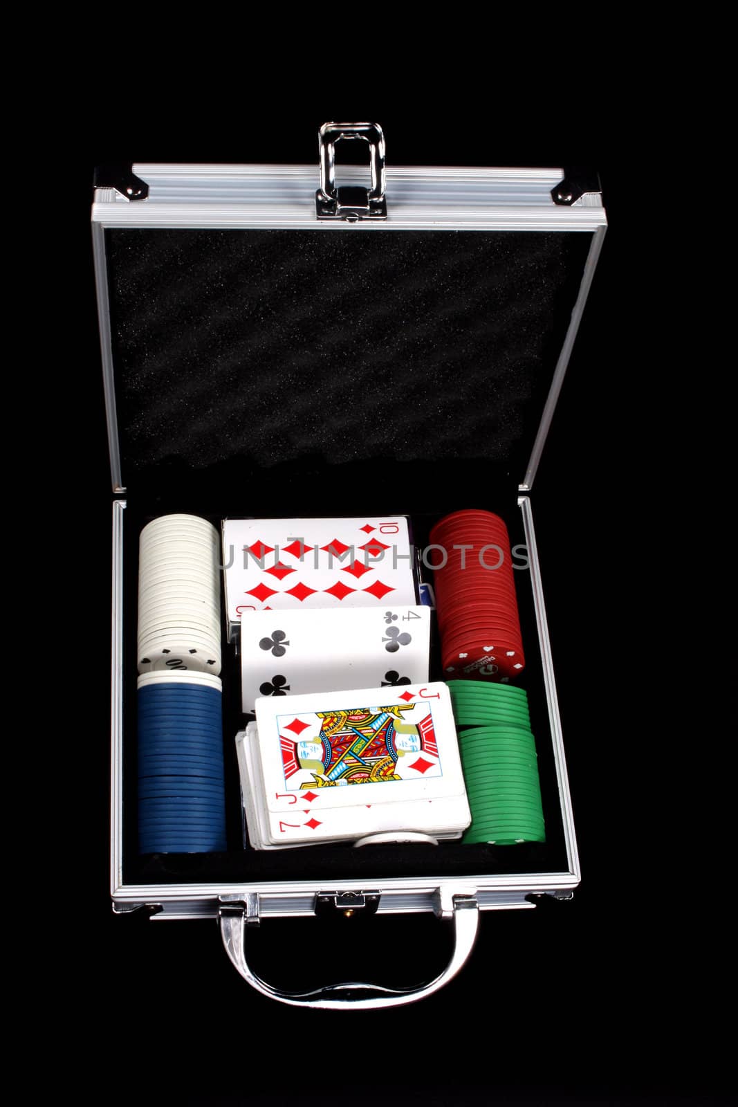 A silver casino box containing cards, counters and dices, isolated on black background.