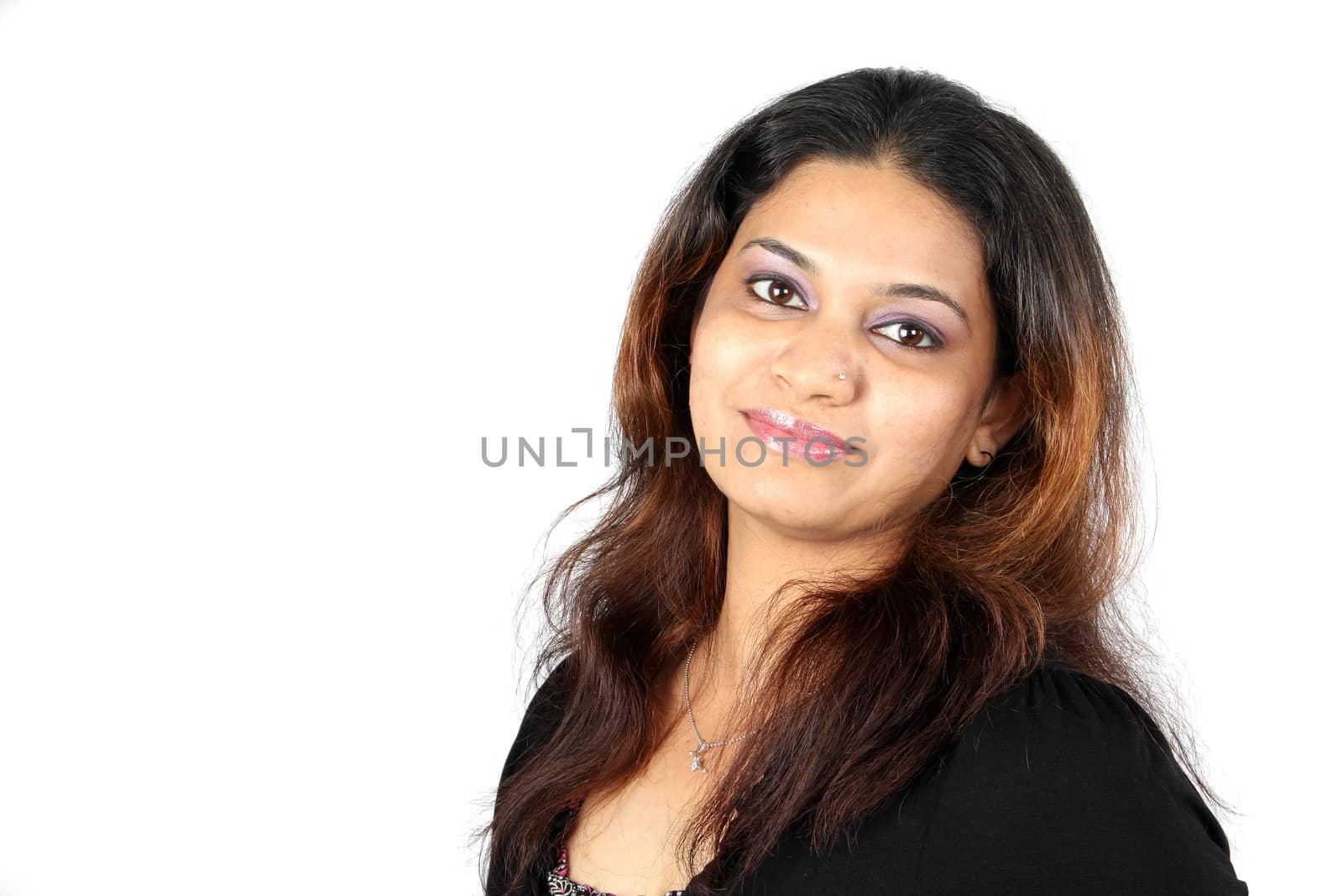 A portrait of a pretty Indian teenage girl, on white studio background.