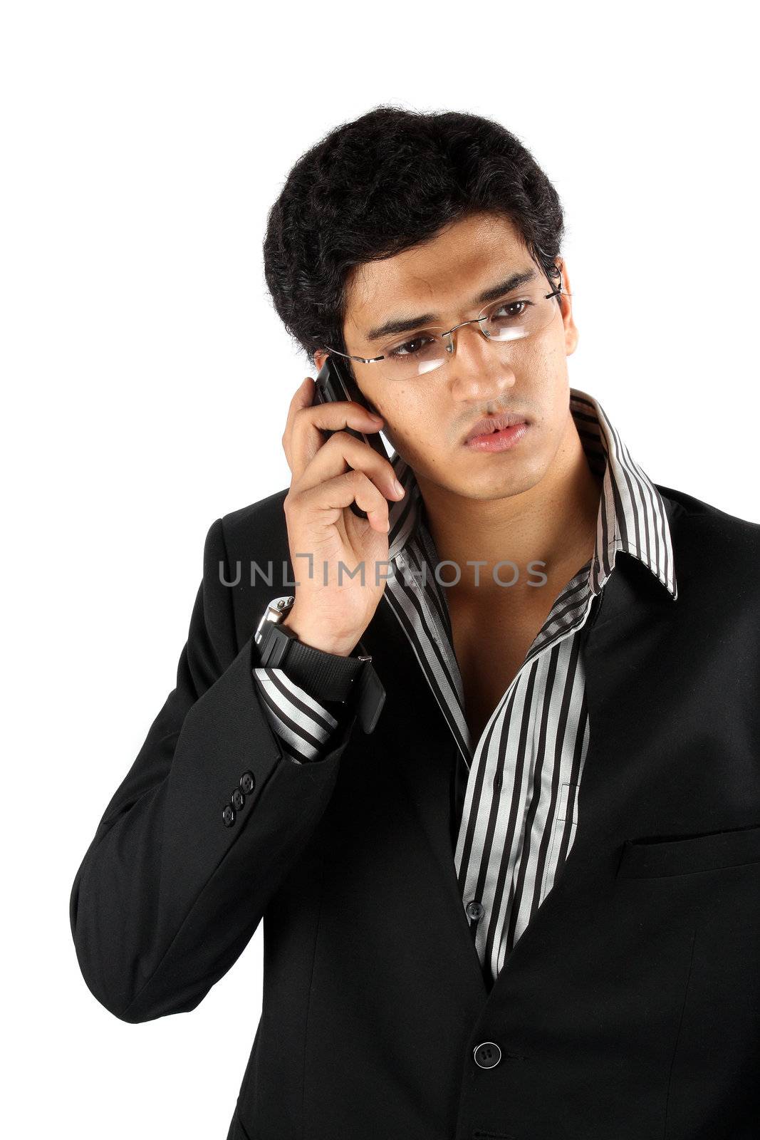 A young Indian businessman talking on his cellphone.