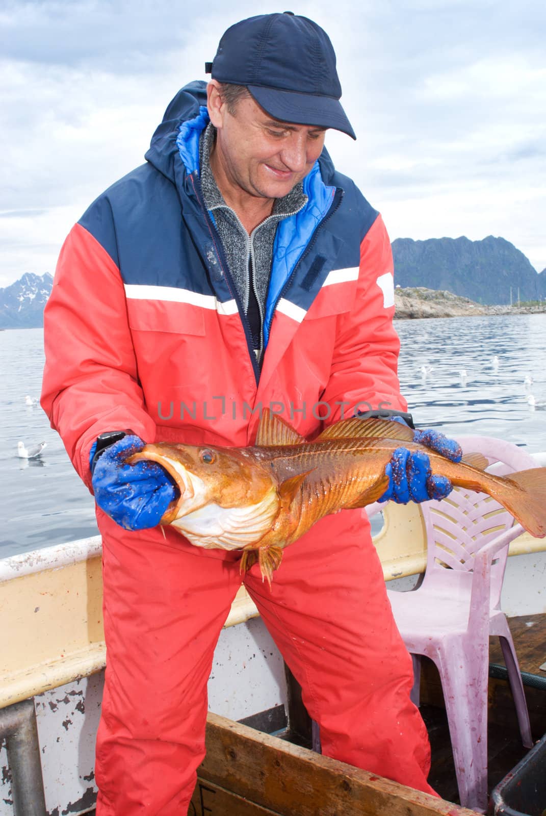 Fisherman with big fish on the boat 