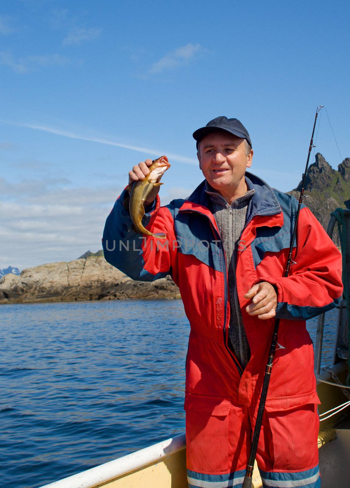 Fisherman with big fish on the boat near the Lofoten island
