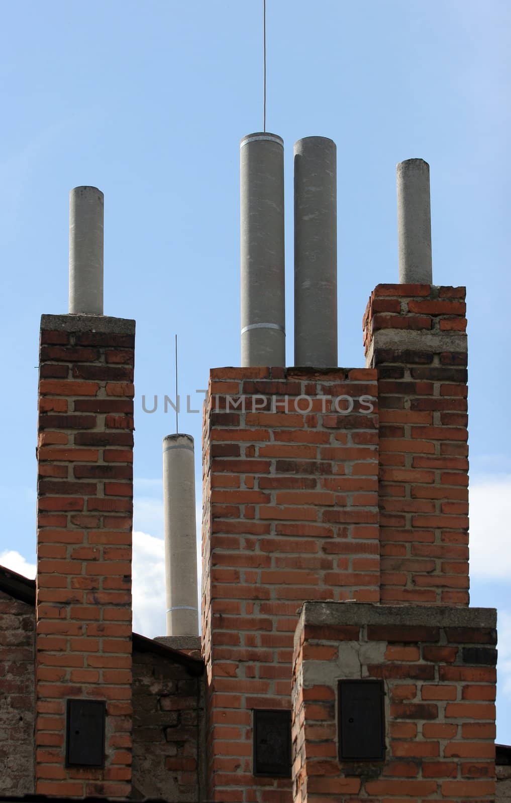 Many of brick chimneys on the top of the house