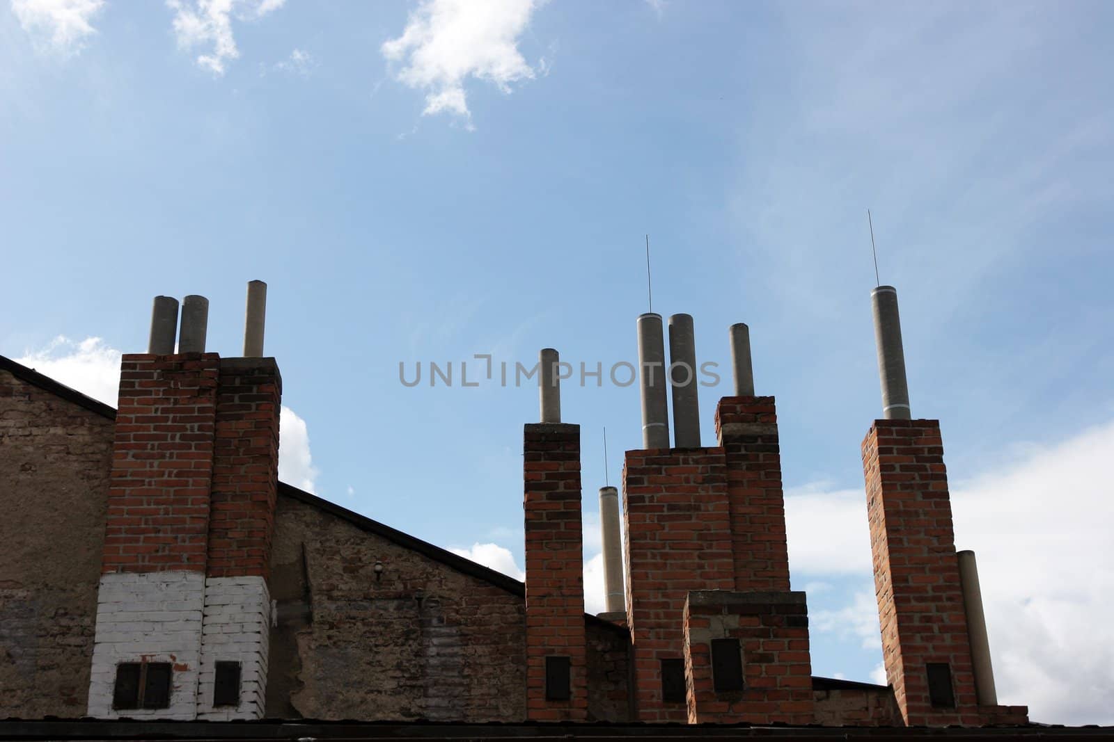 Many of brick chimneys on the top of the house