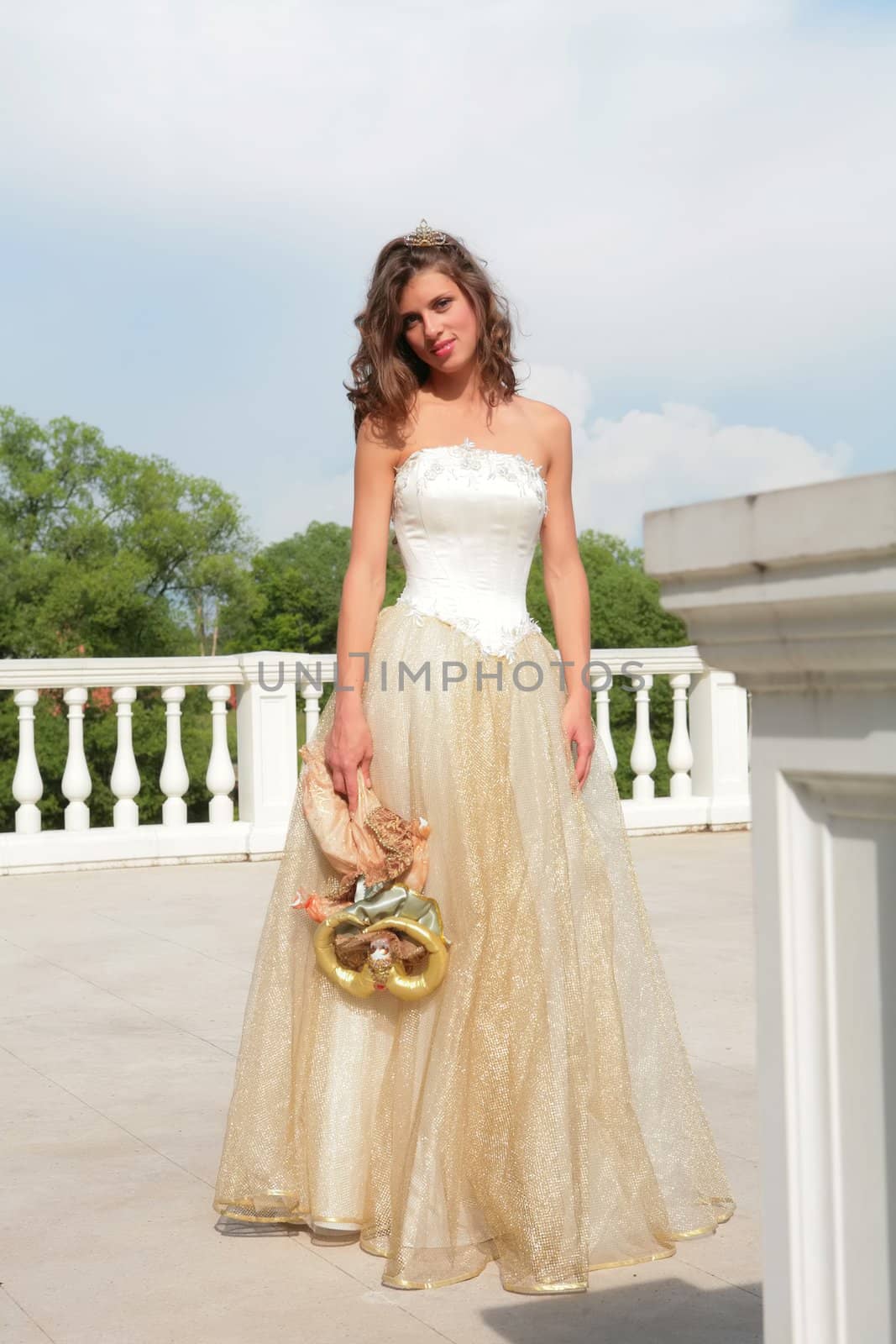 dark-haired girl in gown of the bride and with doll in hand