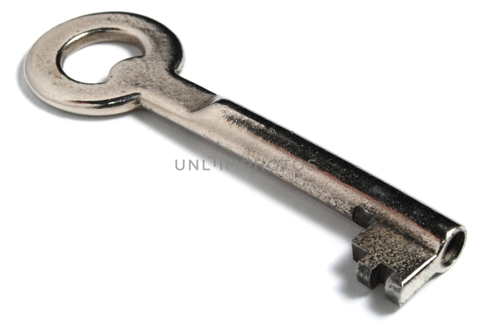 Steel key on white with soft shadow.