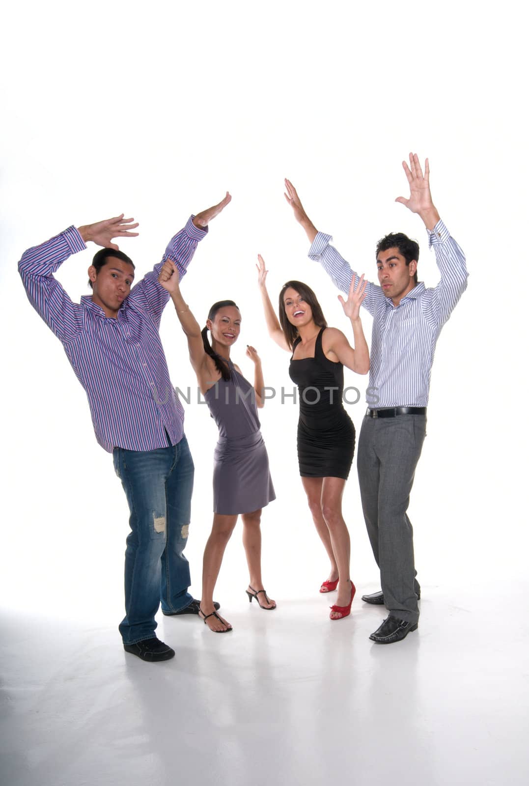 Group of multiracial young adults raising hands with positive attitude.