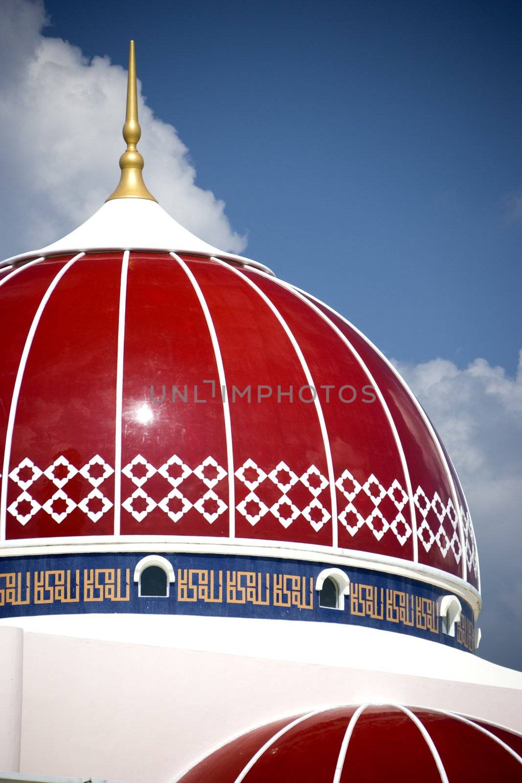 A modern red domed mosque in Malaysia.