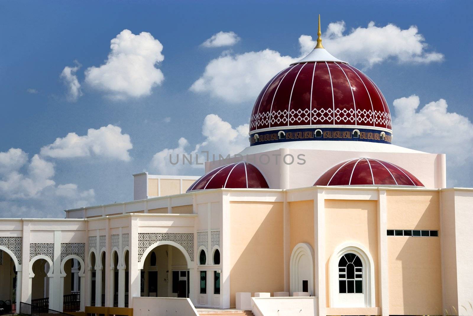 A modern red domed mosque in Malaysia.