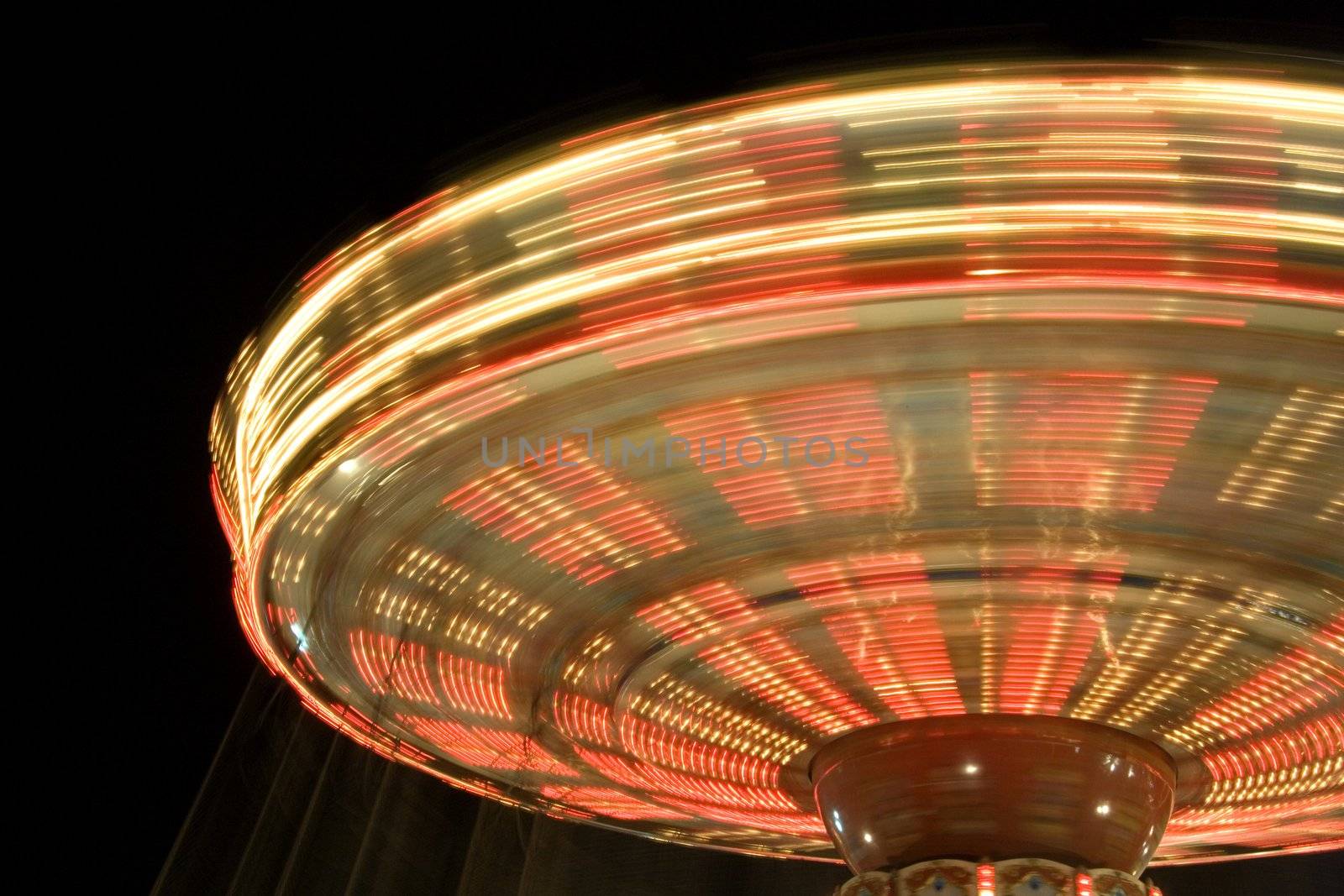 Image of a merry-go-round at night in Kuala Lumpur, Malaysia. Image shot at slow speed to capture motion blur.