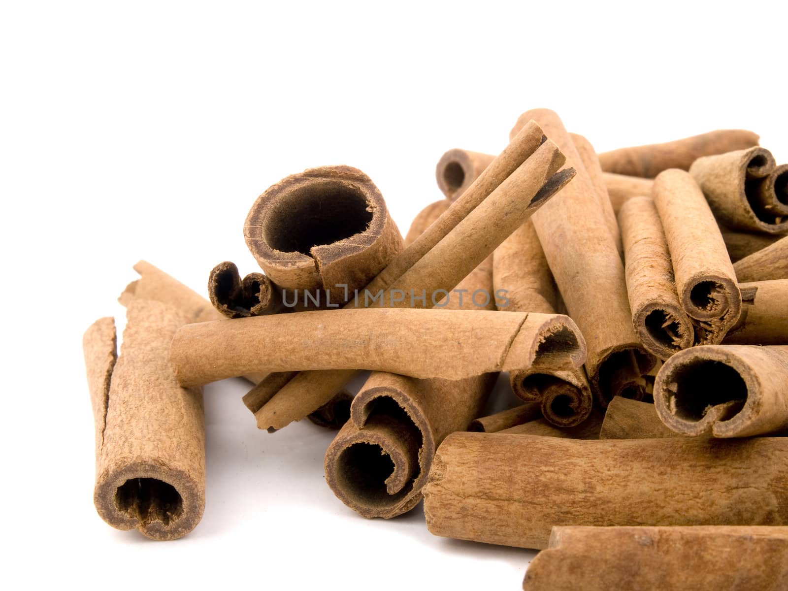 Closeup picture of aromatic cinnamon on white background