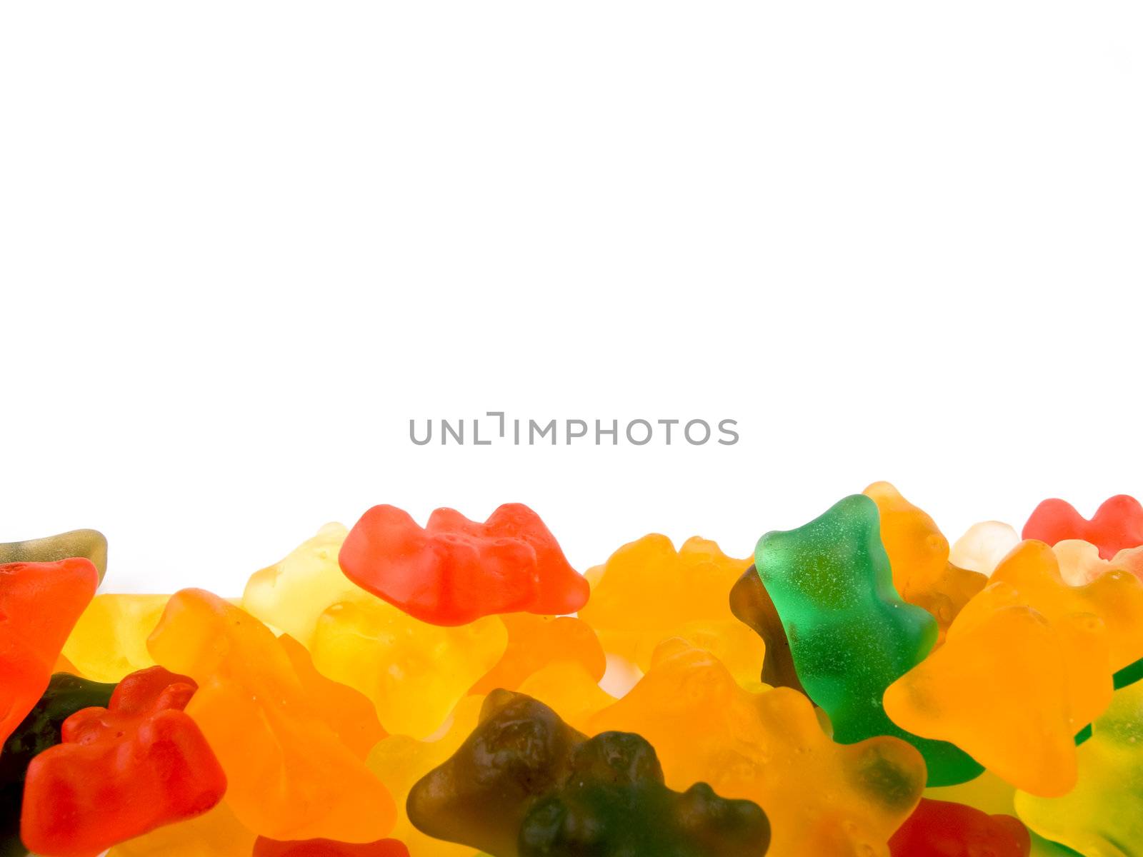 Lots of gummy bears on white background.