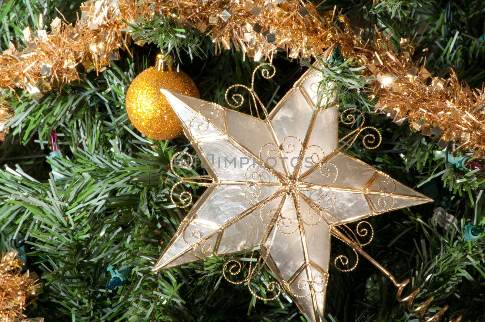 Christmas tree detail with star and ball ornaments.