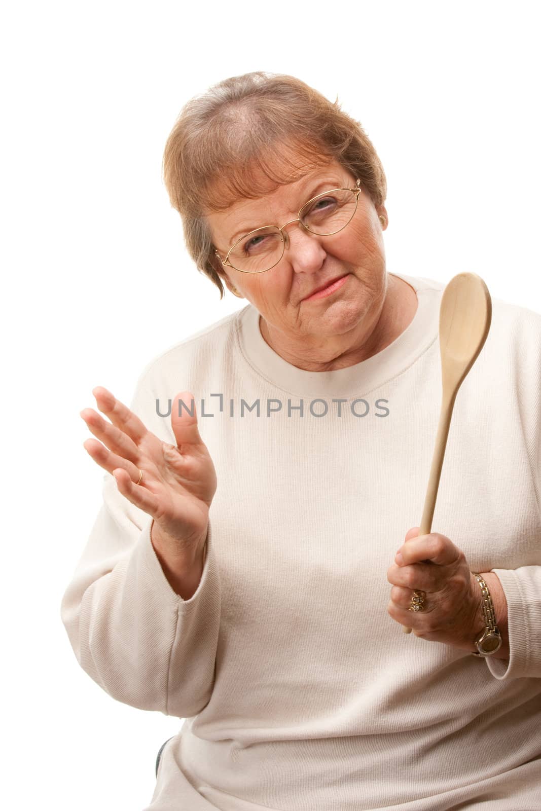 Upset Senior Woman with The Wooden Spoon Isolated on a White Background.