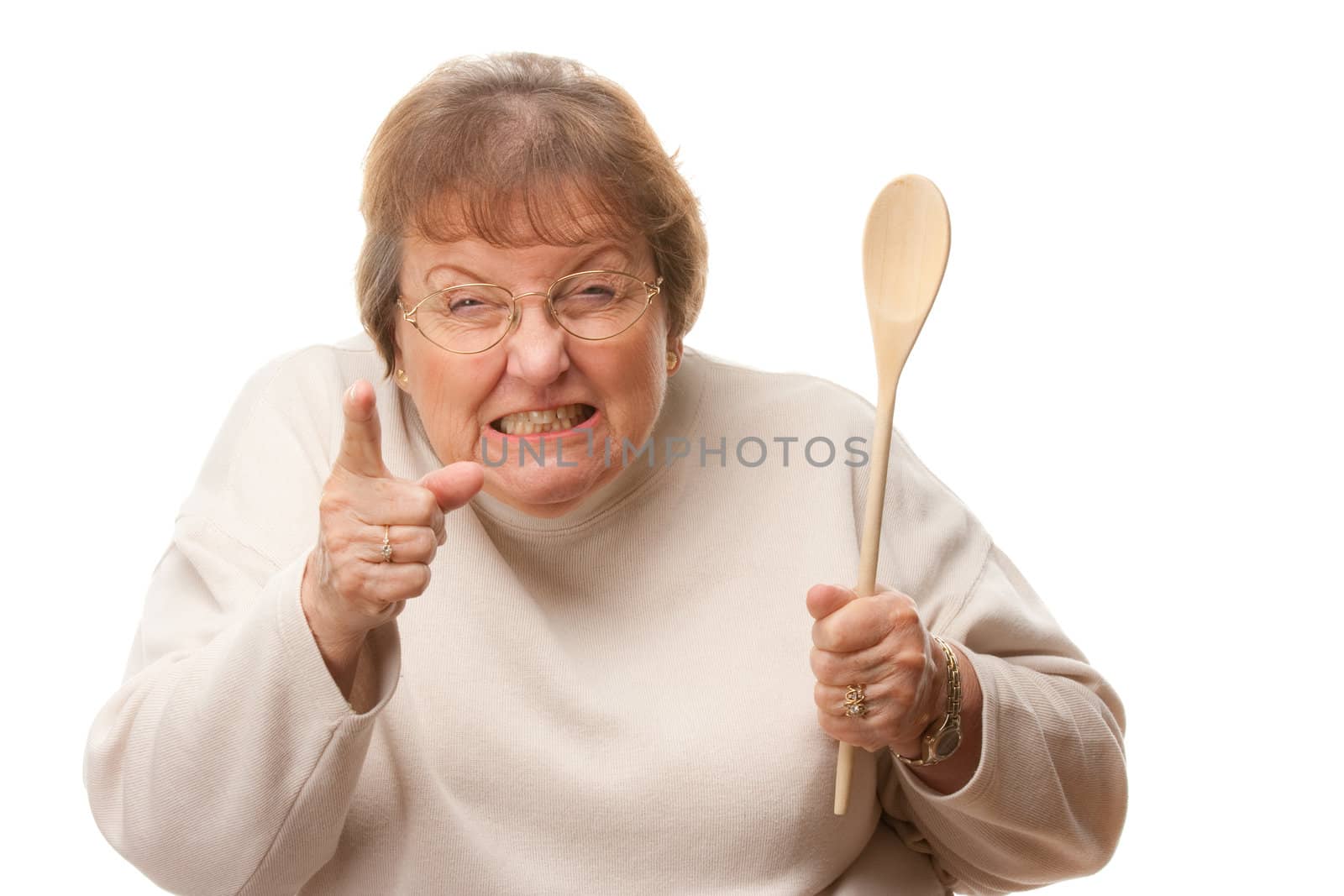 Upset Senior Woman with The Wooden Spoon Isolated on a White Background.