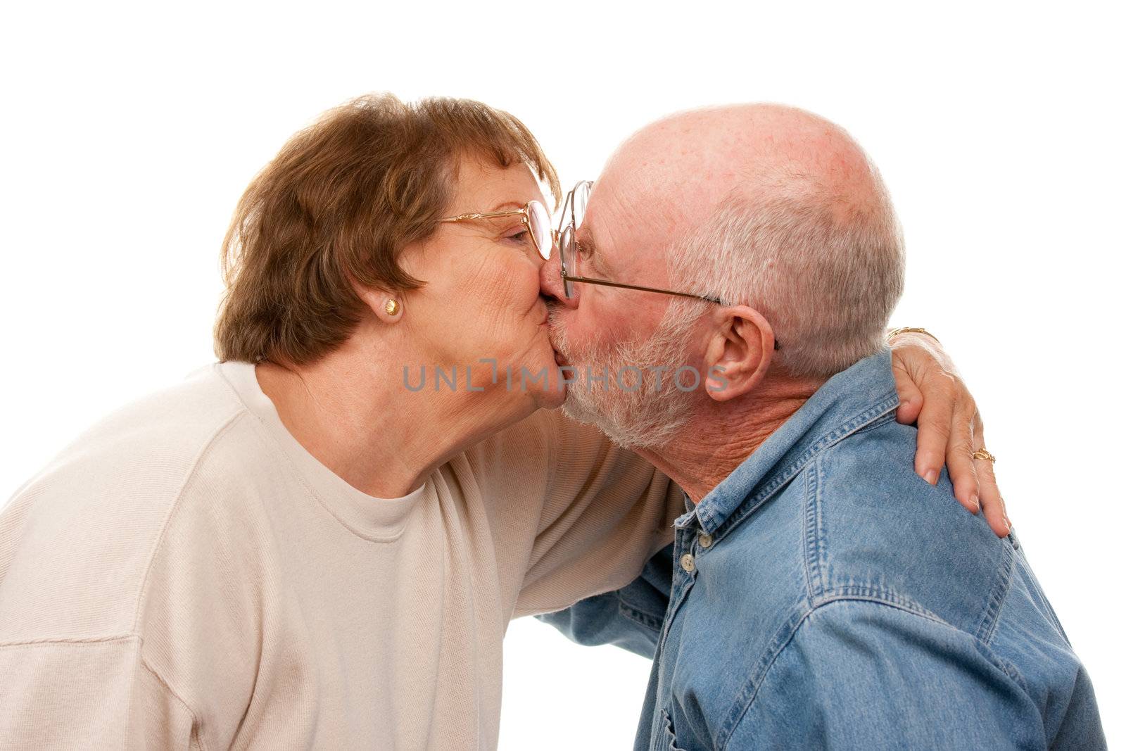 Affectionate Senior Couple Kissing by Feverpitched