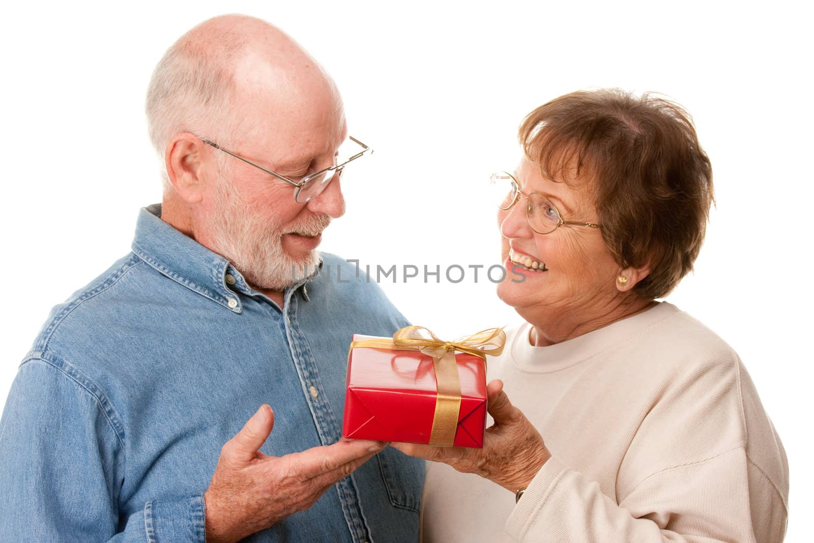 Happy Senior Couple with Gift Isolated on a White Background.