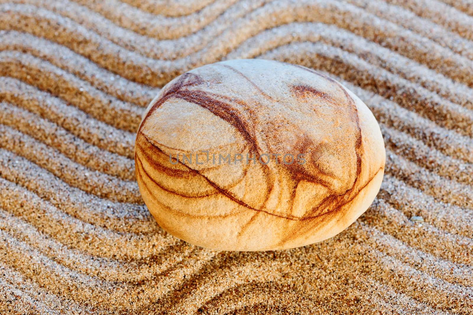 The beautiful figured stone easy lays on sand