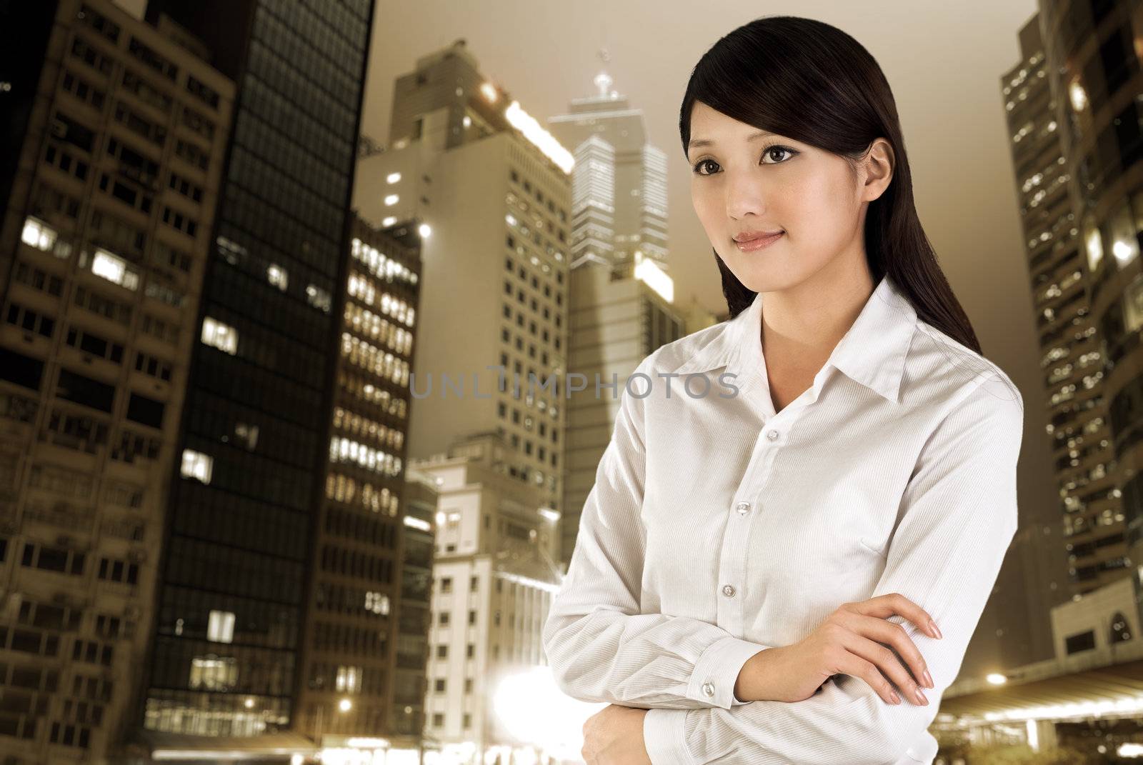 Business woman outdoor, closeup portrait of Asian with skyscraper and office buildings in night in modern city.