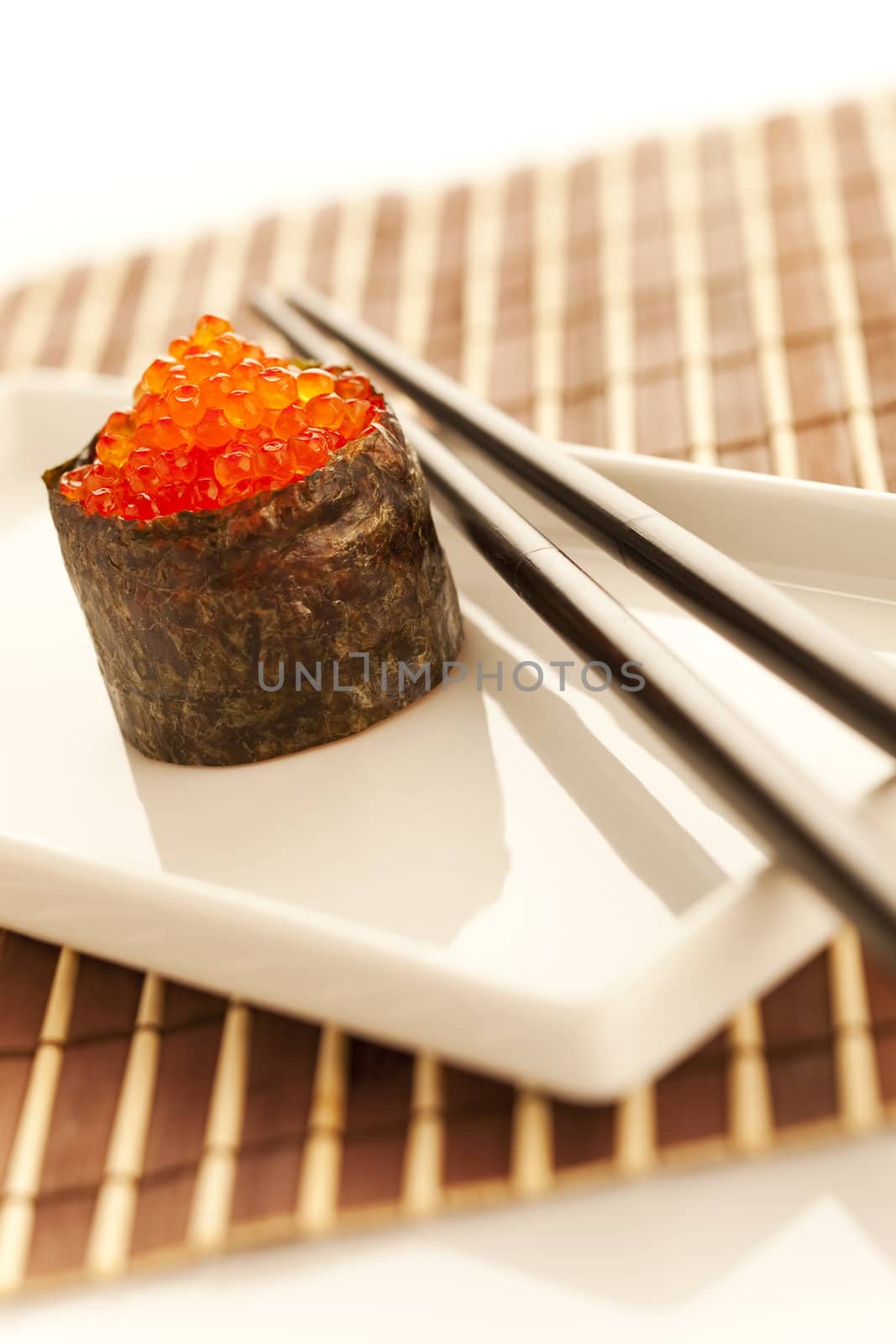 Salmon roe  seaweed sushi roll on the bamboo table