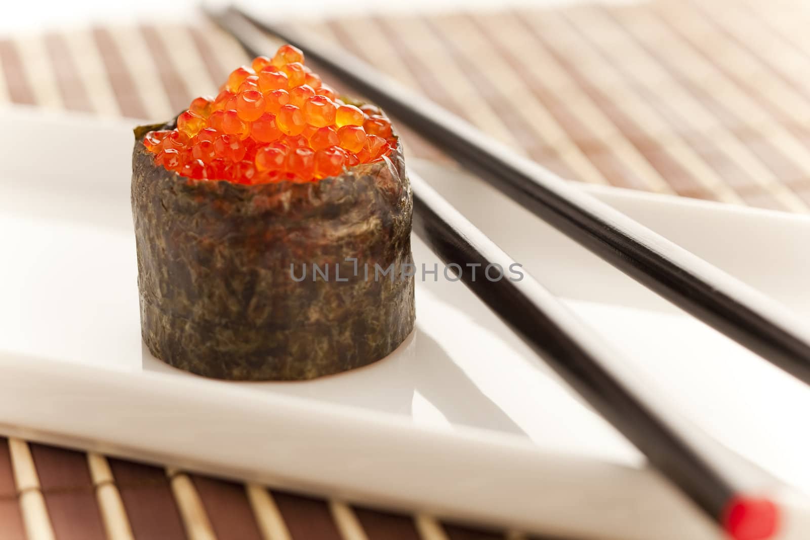 Salmon roe  seaweed sushi roll on the bamboo table