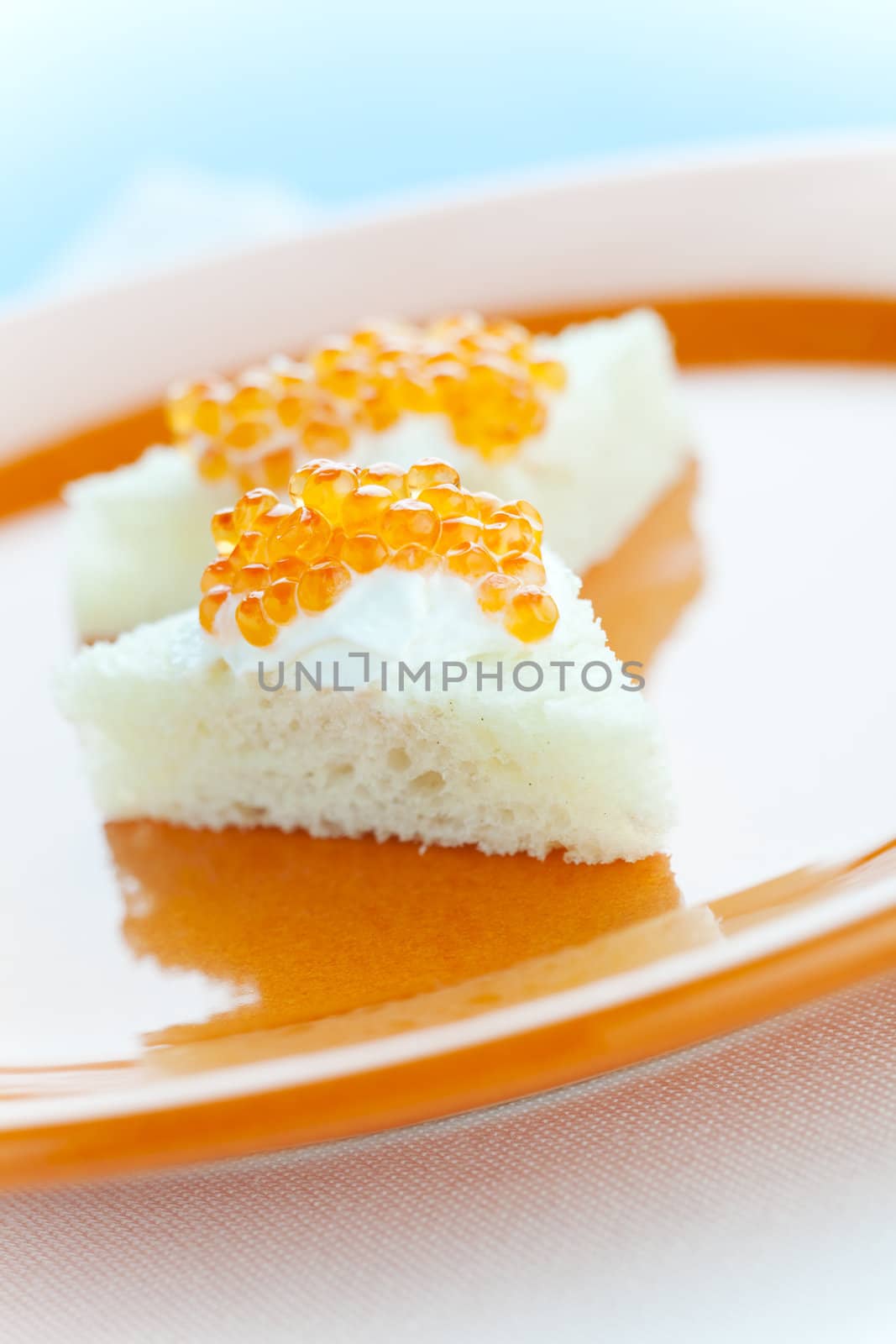 Salmon roe on the bread slice with sour cream