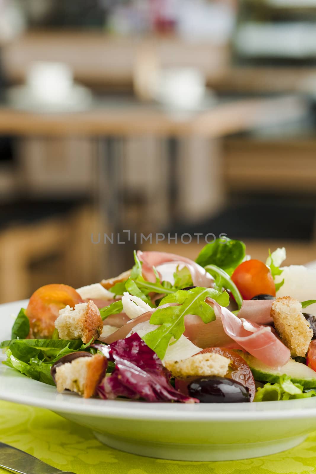 Side salad on the plate (tomato, cucumber, bread, parmesan, ham)