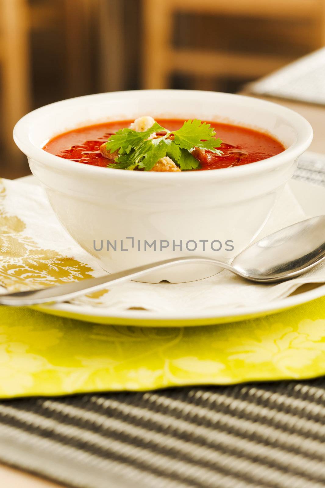 Tomato soup with bread crumps and leaves